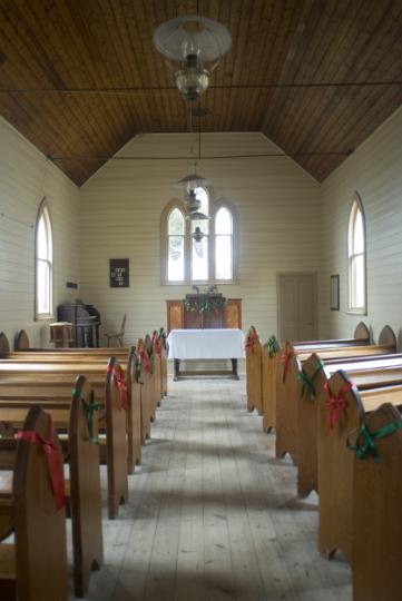 small_historic_church.jpg - Small historic church interior looking down the stone aisle past the wooden pews to the simple alter at the opposite end - non commerical use only