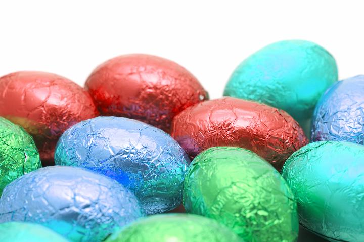 colorful_chocolate_eggs.jpg - Background of a collection of colorful foil wrapped chocolate Easter Eggs with a shallow depth of field