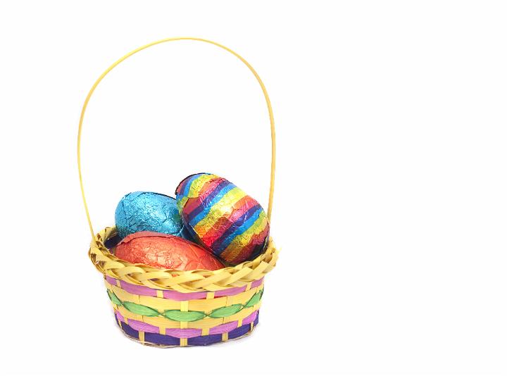 easter_basket.jpg - Decorative basket filled with colourful Easter Eggs in shiny foil wrapping on a white background