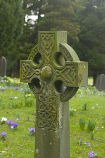 stone_cross.jpg - Background closeup of an ornate stone Celtic Cross in a country graveyard