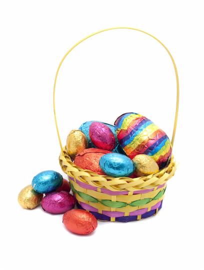 basket_of_eggs.jpg - Pretty decorative basket of colourful foil wrapped chocolate Easter Eggs on a white studio background